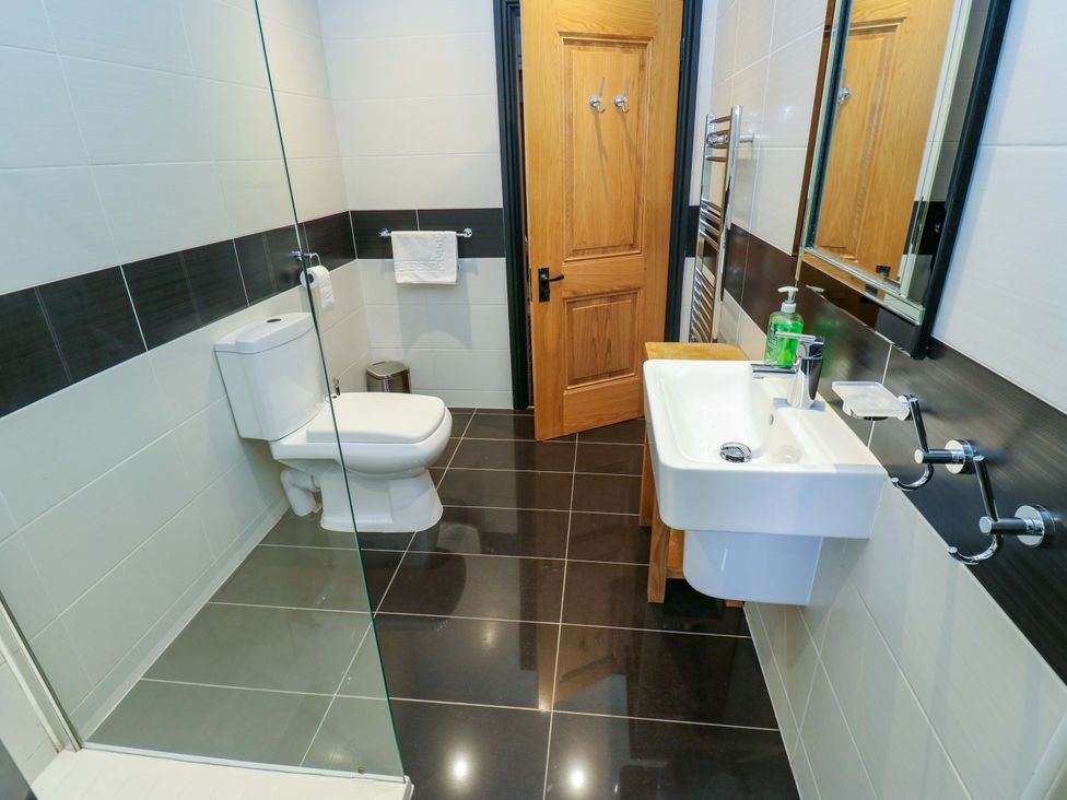 A bathroom with a shower and sink at Bib Knowl Farm Littleborough