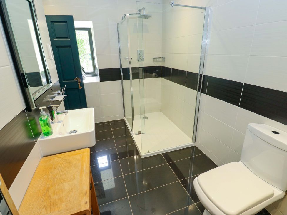 A bathroom with shower, toilet, and sink at Bib Knowl Farm in Littleborough
