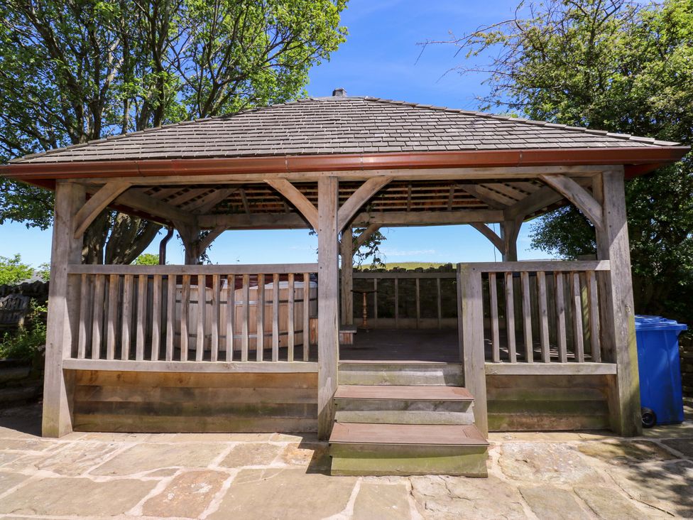 A gazebo with wooden railings and steps at Bib Knowl Farm Littleborough
