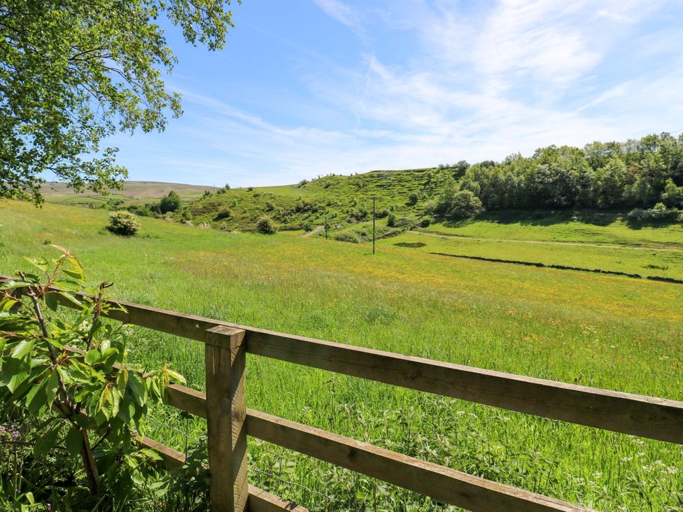 A view of a grassy field and trees at Bib Knowl Farm in Littleborough