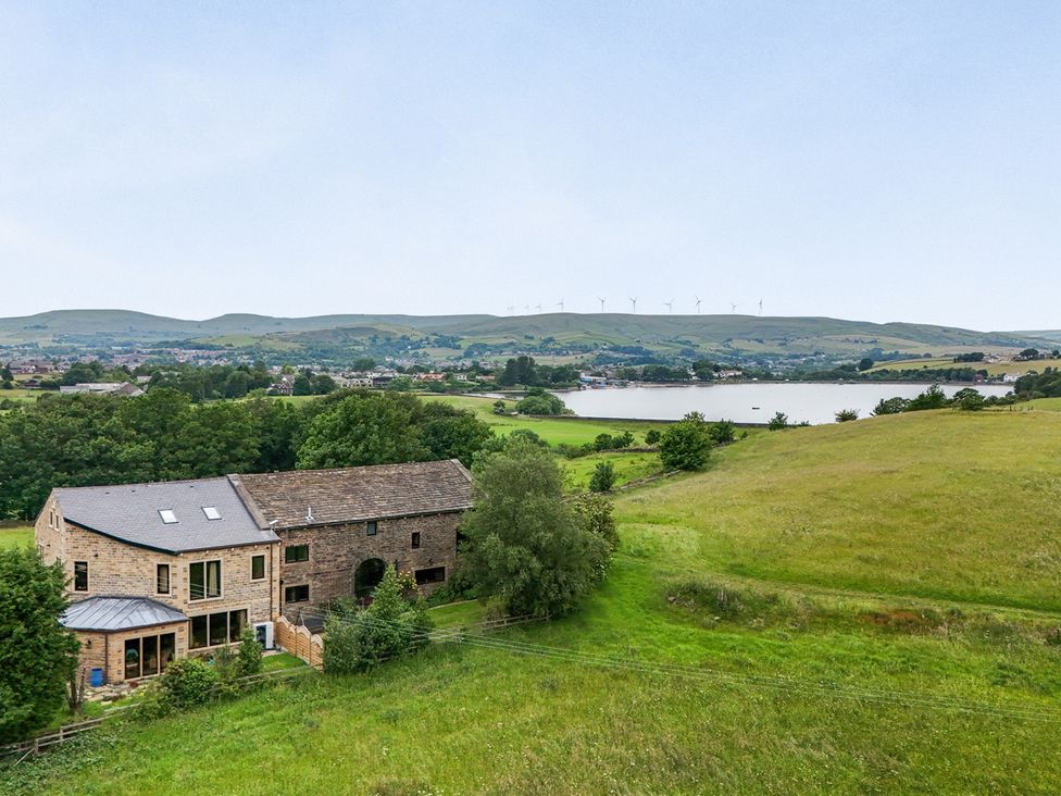 An outdoor view of a house near a lake at Bib Knowl Farm Littleborough