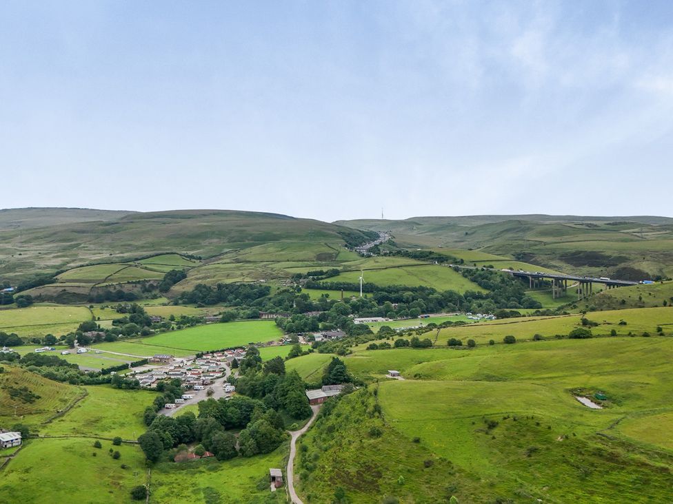 A panoramic view of hills and fields at Bib Knowl Farm in Littleborough