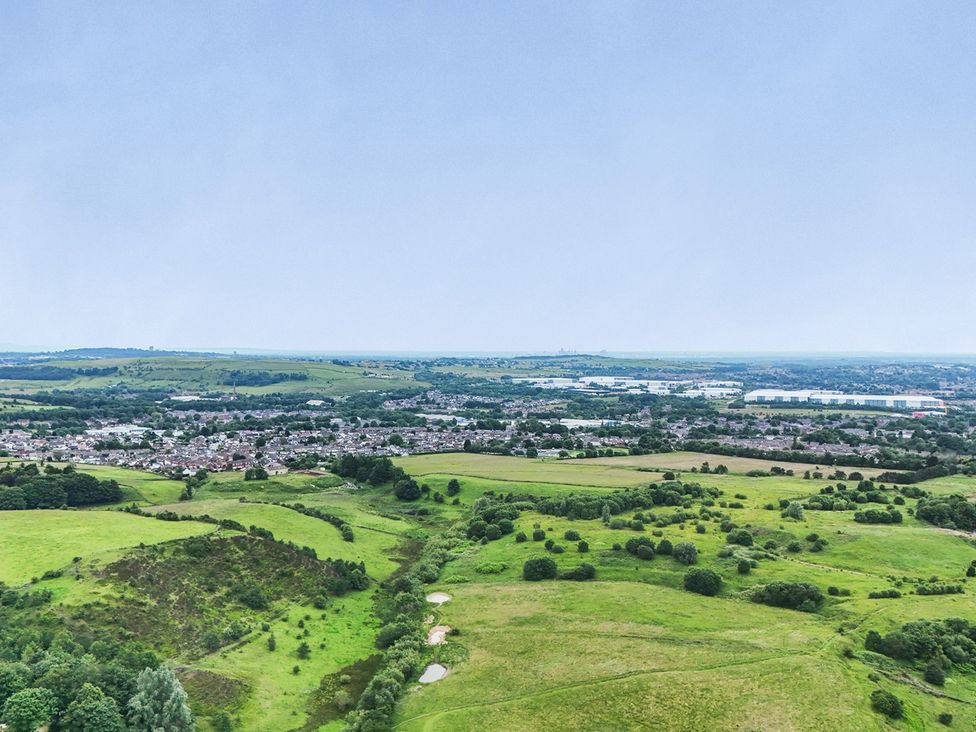 An aerial view of hills and a residential area near Littleborough
