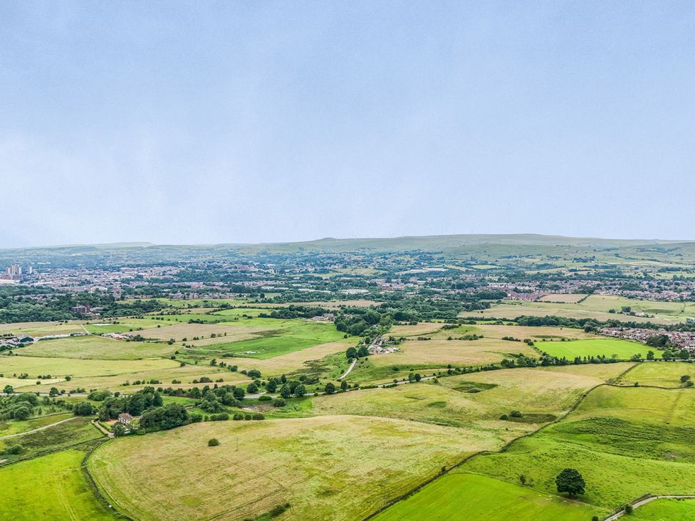 A view of fields and hills from above at Bib Knowl Farm in Littleborough