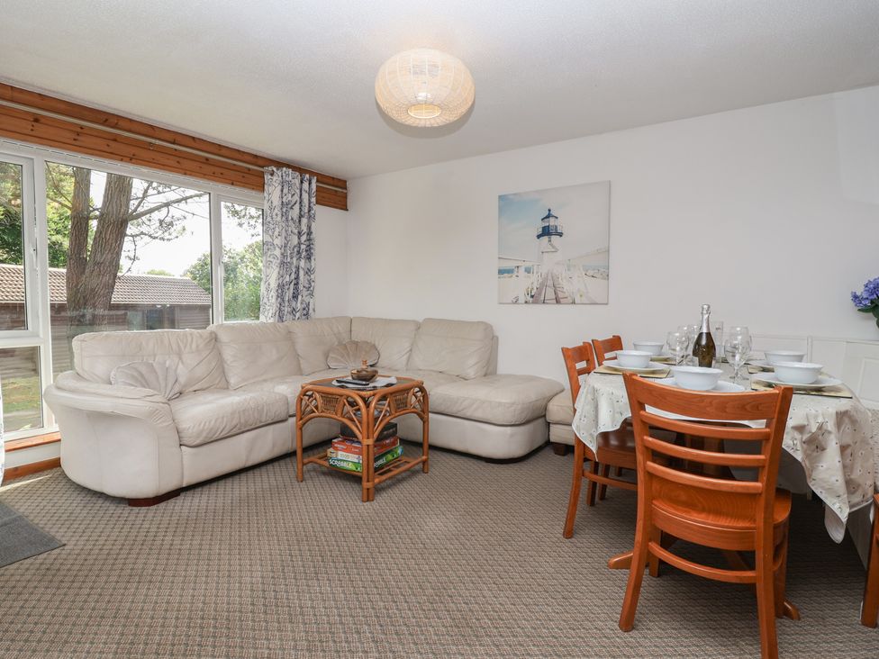 A living room with a sofa and a dining table at Manorcombe 1 Honicombe Park near Gunnislake