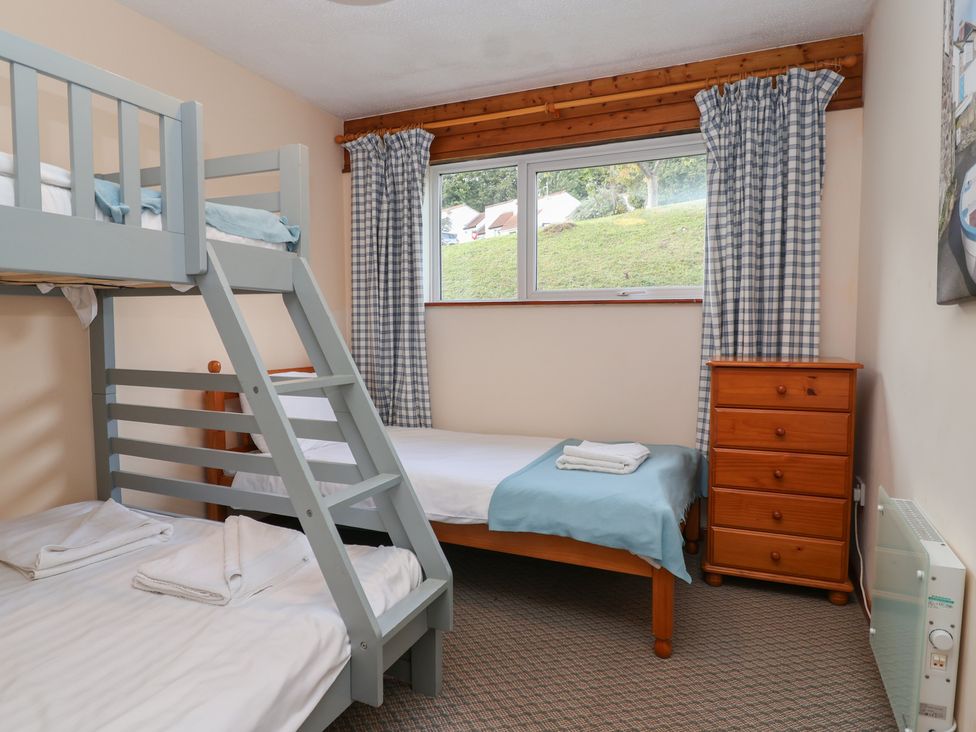 A bedroom with a bunk bed and a single bed at Manorcombe 1 Honicombe Park near Gunnislake