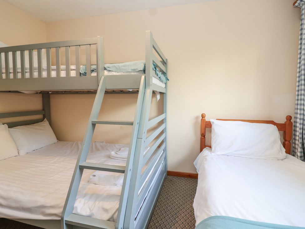 A bedroom with a bunk bed and a double bed at Manorcombe 1 Honicombe Park near Gunnislake