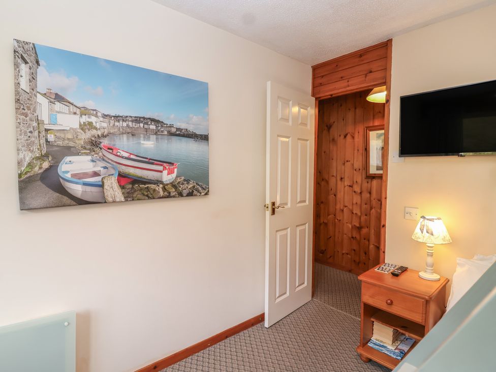 A hallway featuring a photograph and a lamp at Manorcombe 1 Honicombe Park near Gunnislake