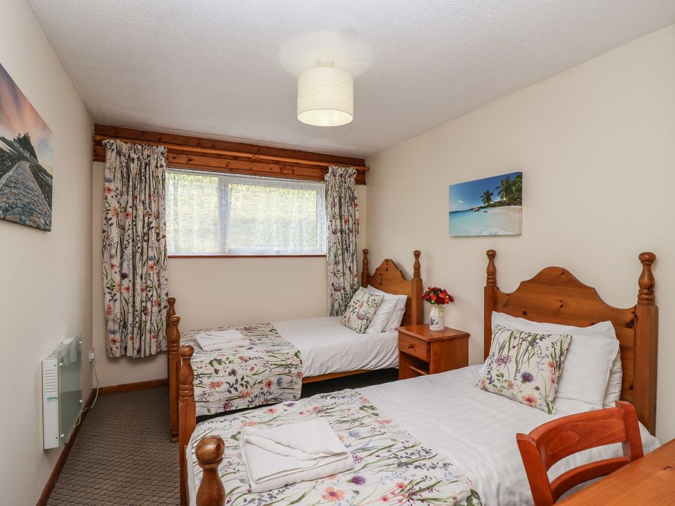 A bedroom with two beds and a window at Manorcombe 1 in Honicombe Park near Gunnislake