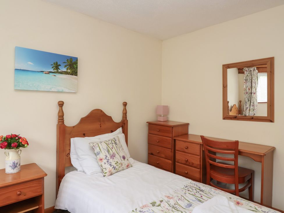 A bedroom with a bed and dresser at Manorcombe 1 Honicombe Park near Gunnislake