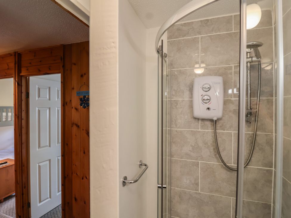 A shower unit with water heater in a bathroom at Manorcombe 1 Honicombe Park near Gunnislake