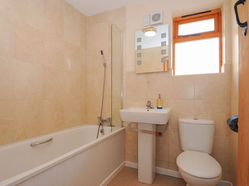 A bathroom with a bath tub sink and toilet at Trevano St Breward