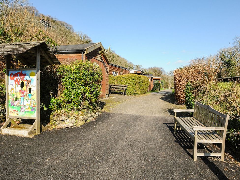 An outdoor area with a pathway and a bench at Trevano in St Breward