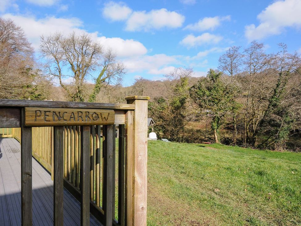 A view of a wooden railing with a sign at Pencarrow in St Breward