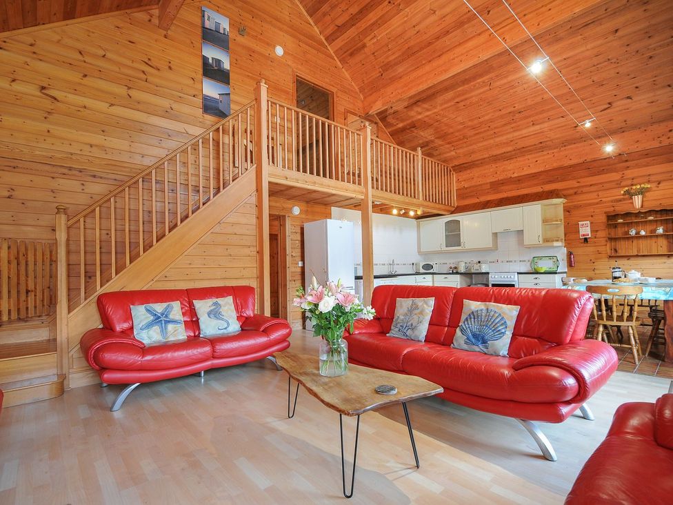 A living room with a sofa and coffee table at Pencarrow in St Breward
