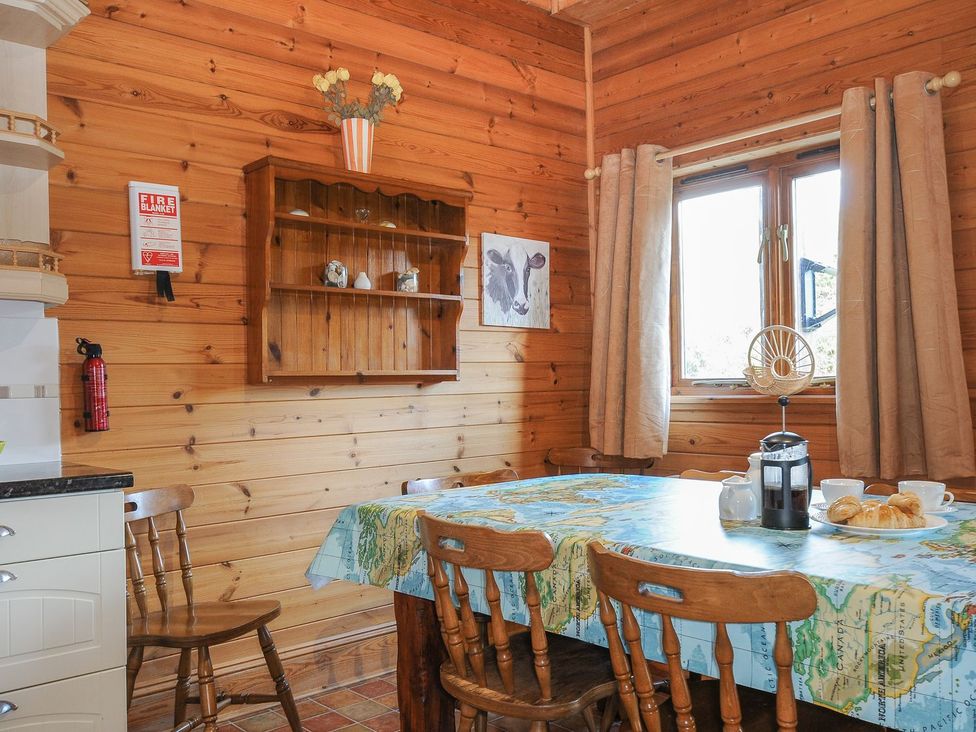 A kitchen with a table and chairs at Pencarrow in St Breward