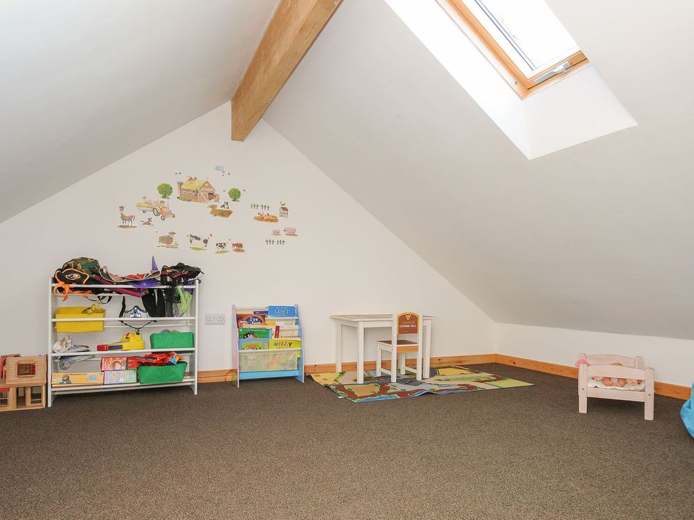 A playroom with a table and chairs at Pencarrow in St Breward