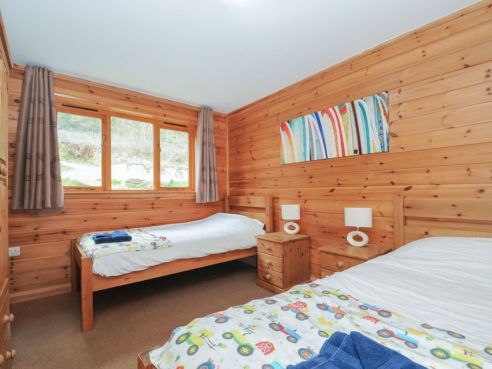 A bedroom with two beds and nightstands at Trebah in St Breward