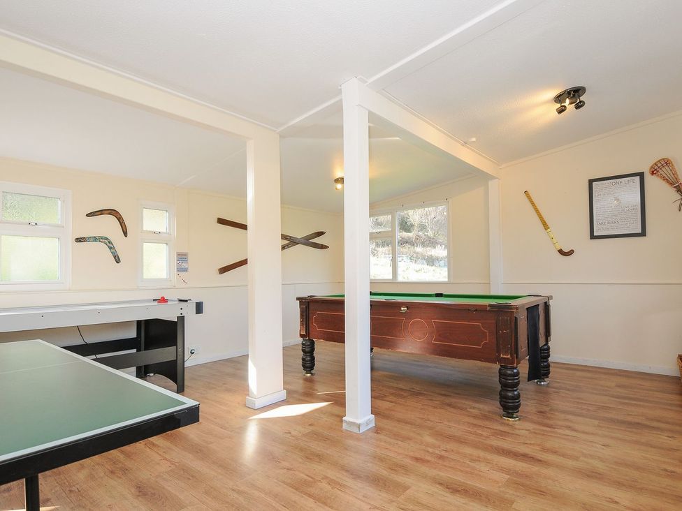 A game room with a pool table and air hockey table at Trebah in St Breward