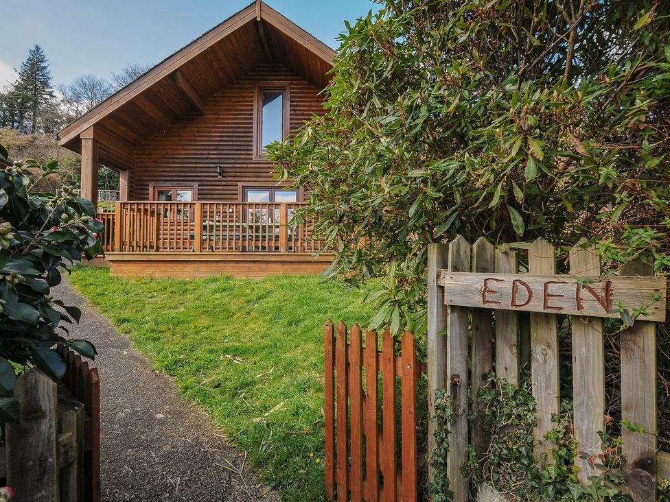 A wooden house with a deck and a sign at Eden in St Breward