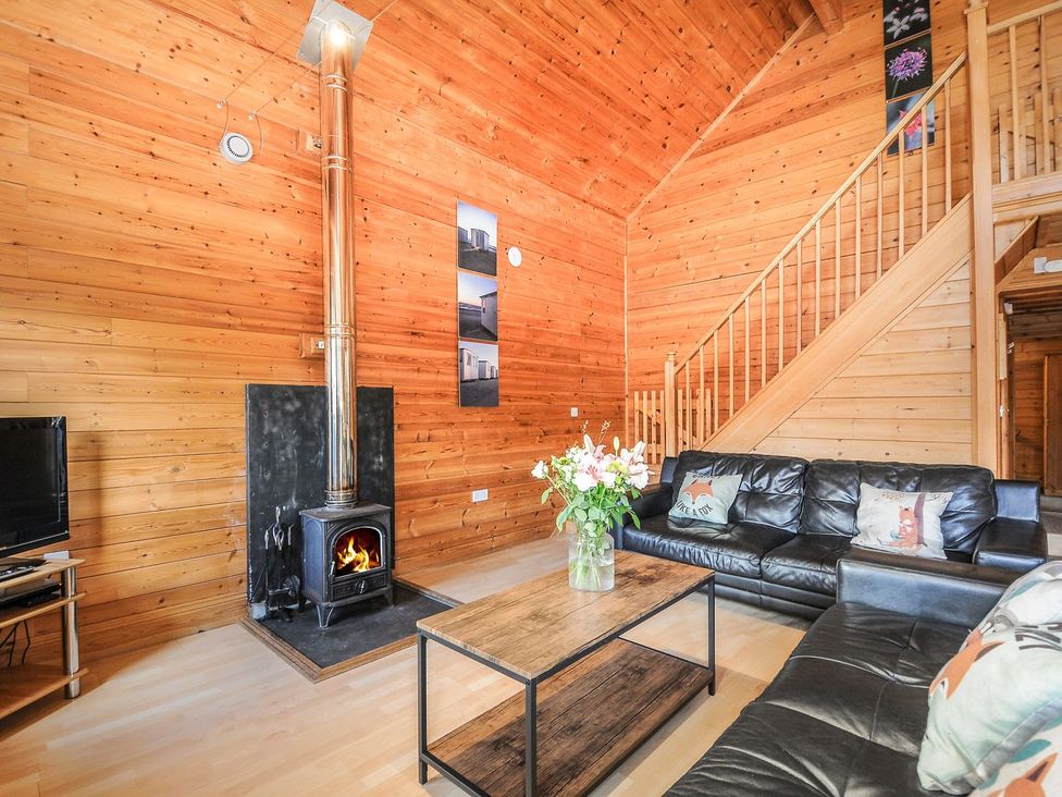 A living room with a sofa and fireplace at Heligan in St Breward