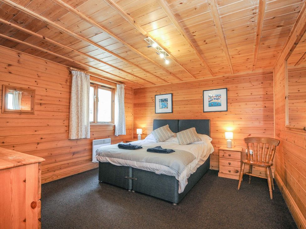 A bedroom with a bed and furniture at Heligan in St Breward