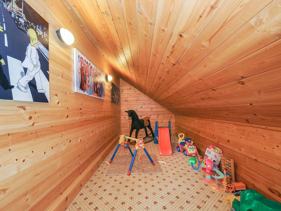 A playroom with toys and sliding toy at Heligan St Breward