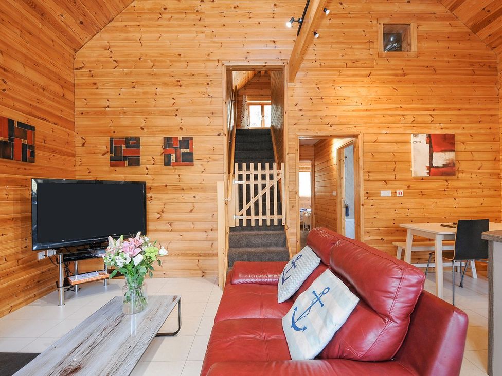 A living room with a sofa and tv at Polzeath in St Breward