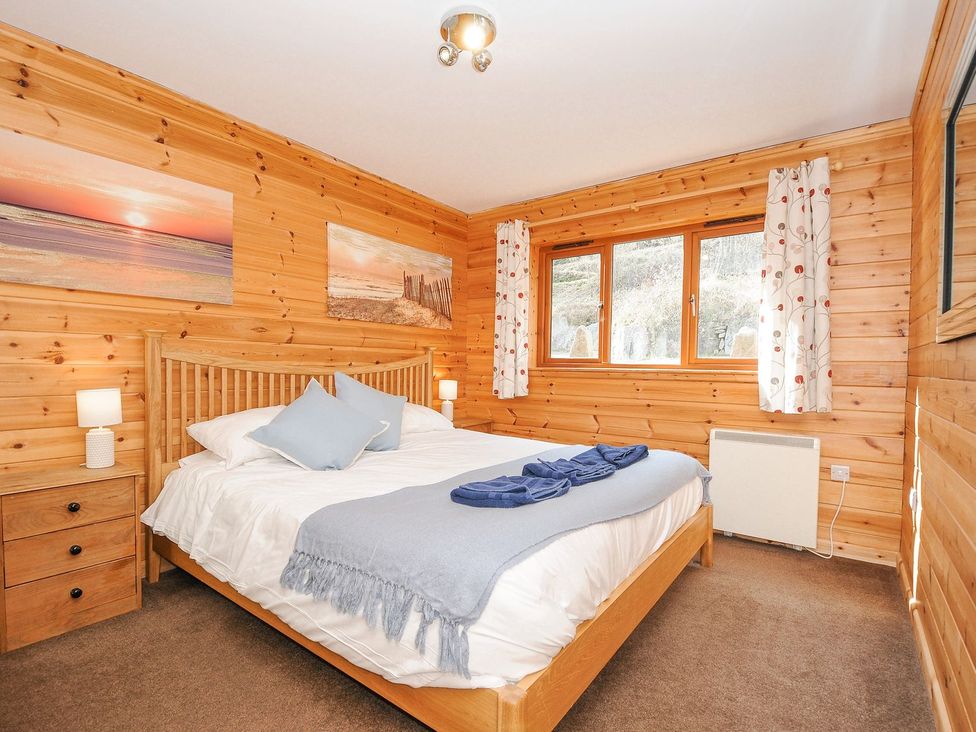 A bedroom with a bed and furniture at Polzeath in St Breward