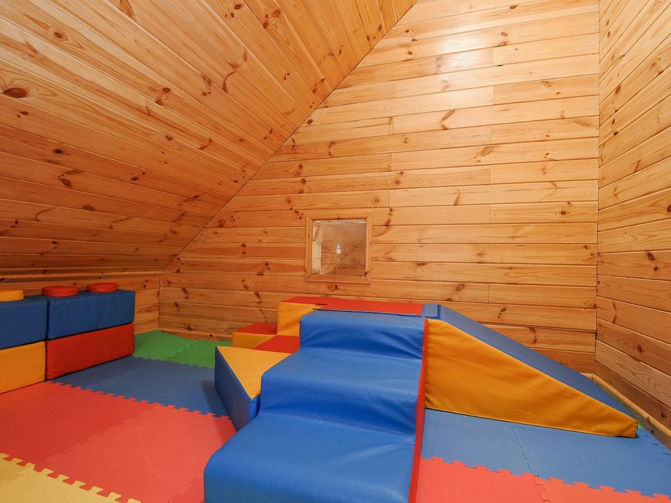 A playroom with foam blocks and colorful mats at Polzeath St Breward