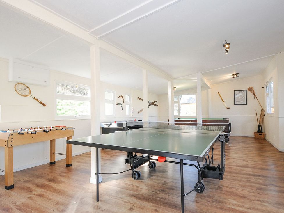 A games room with table tennis and foosball tables at Polzeath in St Breward
