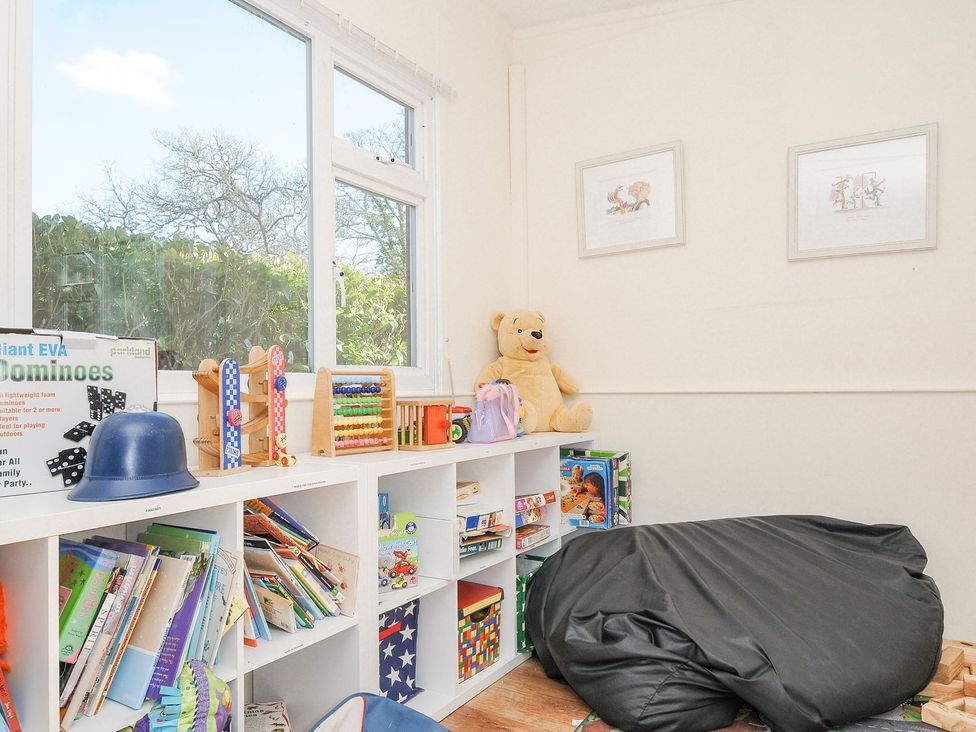 A playroom with a bookshelf and toys at Polzeath in St Breward