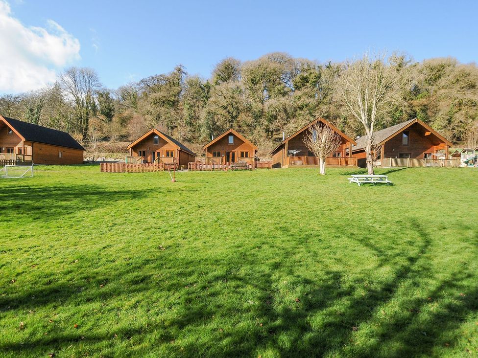 A group of cabins with a picnic table in the outdoor area at Polzeath in St Breward