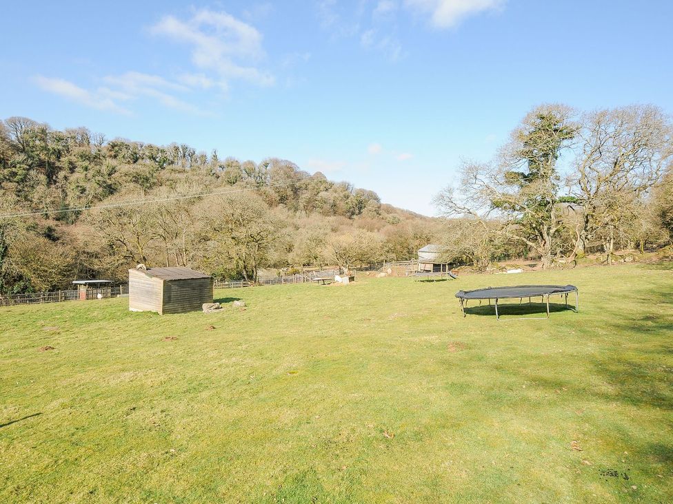 An outdoor area with a trampoline and a shed at Polzeath in St Breward