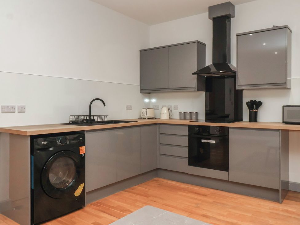 A kitchen with a washing machine and sink at Flat 9 in York