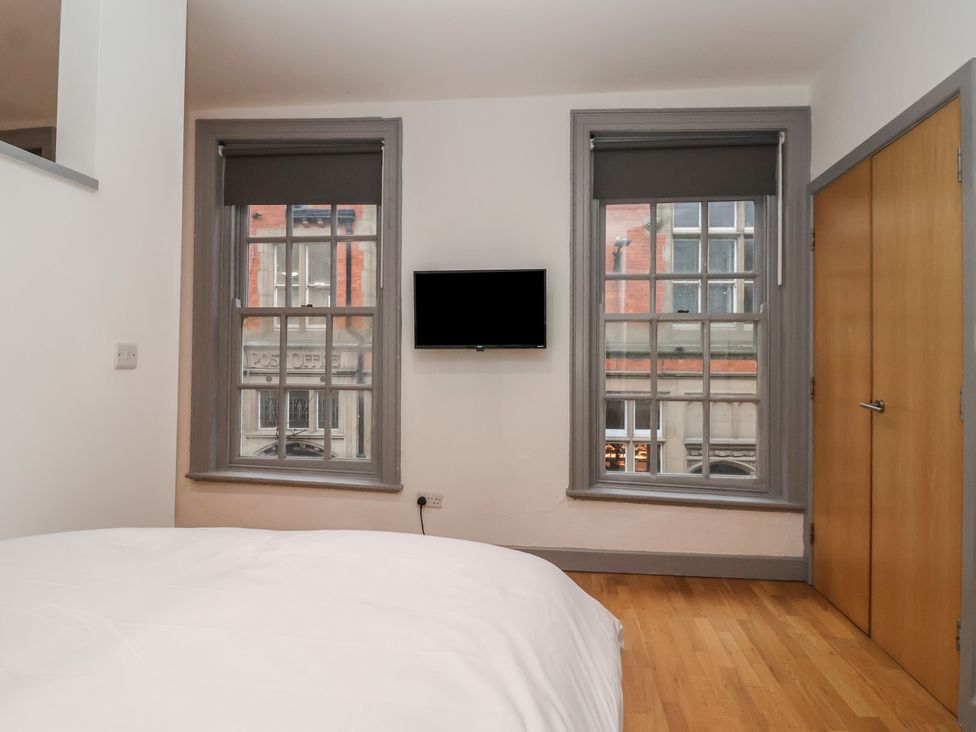 A bedroom with a bed and a television at Flat 9 in York