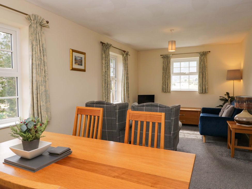 A living room with a dining table and chairs at Buckbarrow in Seascale