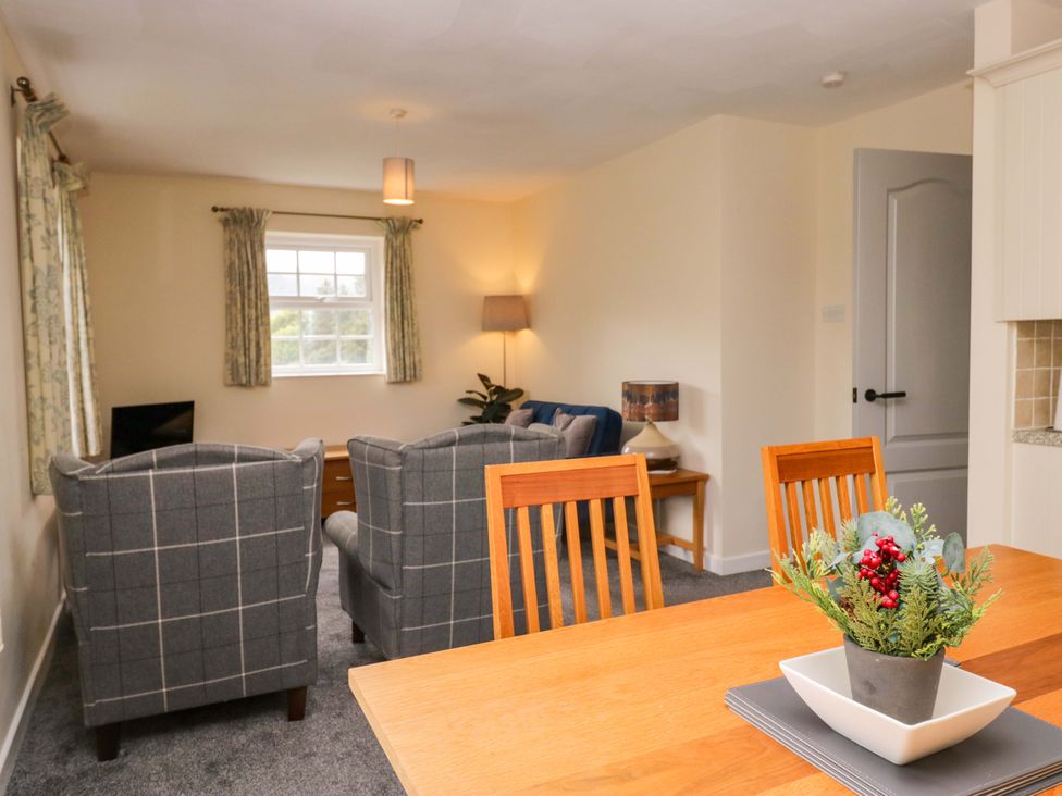 A living room with a sofa and armchairs at Buckbarrow in Seascale