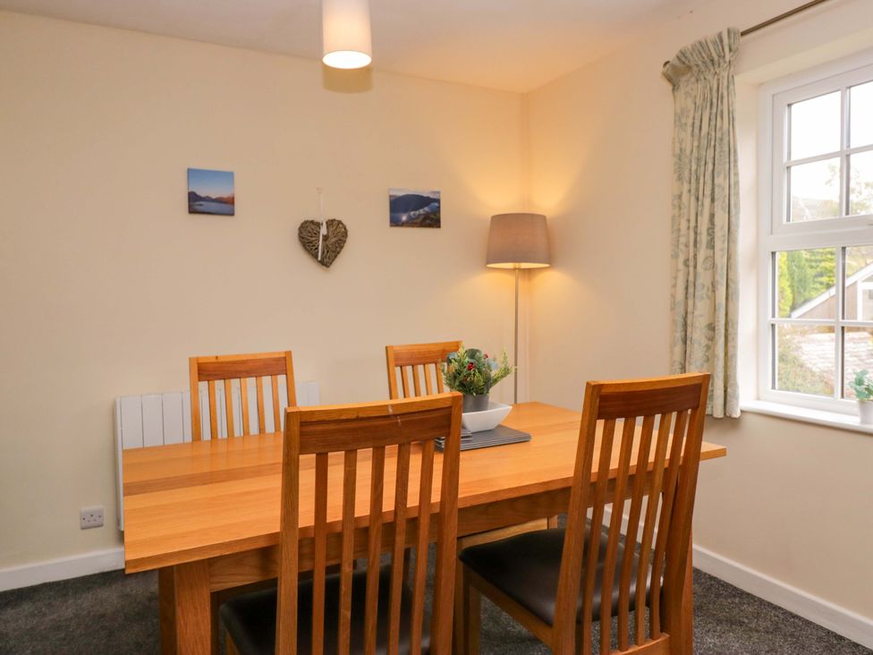 A dining room with a table and four chairs at Buckbarrow in Seascale