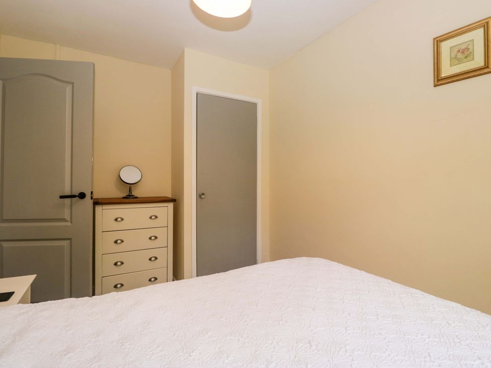 A bedroom with a bed and a drawer at Buckbarrow Seascale