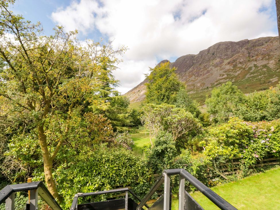A view of a garden with trees and a mountain at Buckbarrow in Seascale