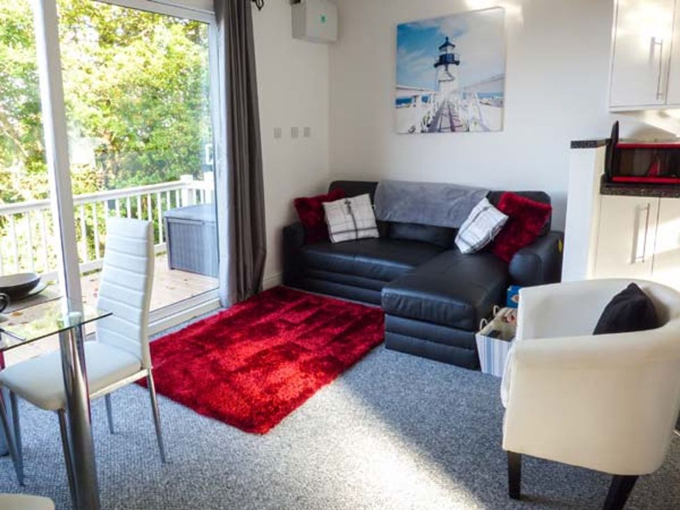 A living room with a sofa and dining table at I C Lundy Too Bideford Bay Holiday Park near Clovelly