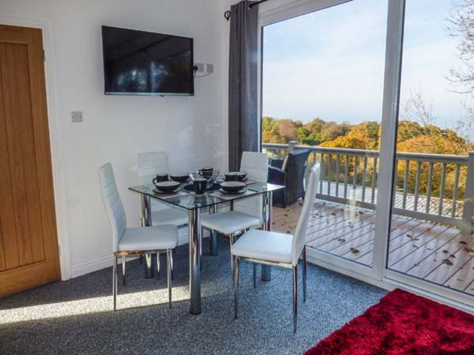 A dining room with a table and chairs at I C Lundy Too Bideford Bay Holiday Park near Clovelly