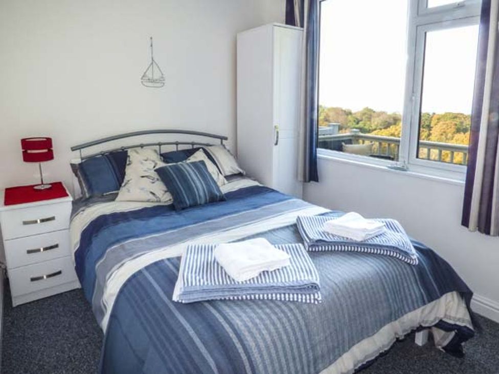 A bedroom with a bed and furnishings at I C Lundy Too near Bideford Bay Holiday Park