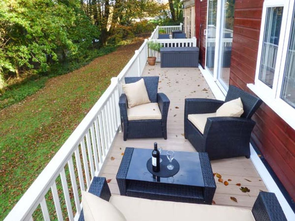 An outdoor seating area with chairs and a table at I C Lundy Too Bideford Bay Holiday Park near Clovelly