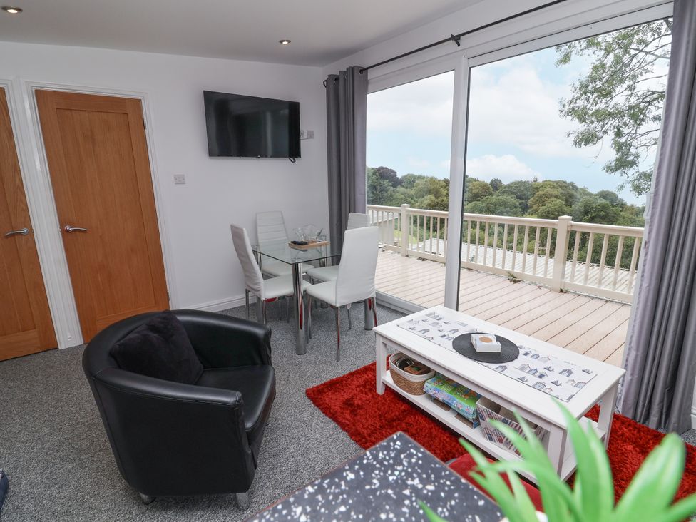 A living room with a dining area and television at I C Lundy Too Bideford Bay Holiday Park near Woolfardisworthy