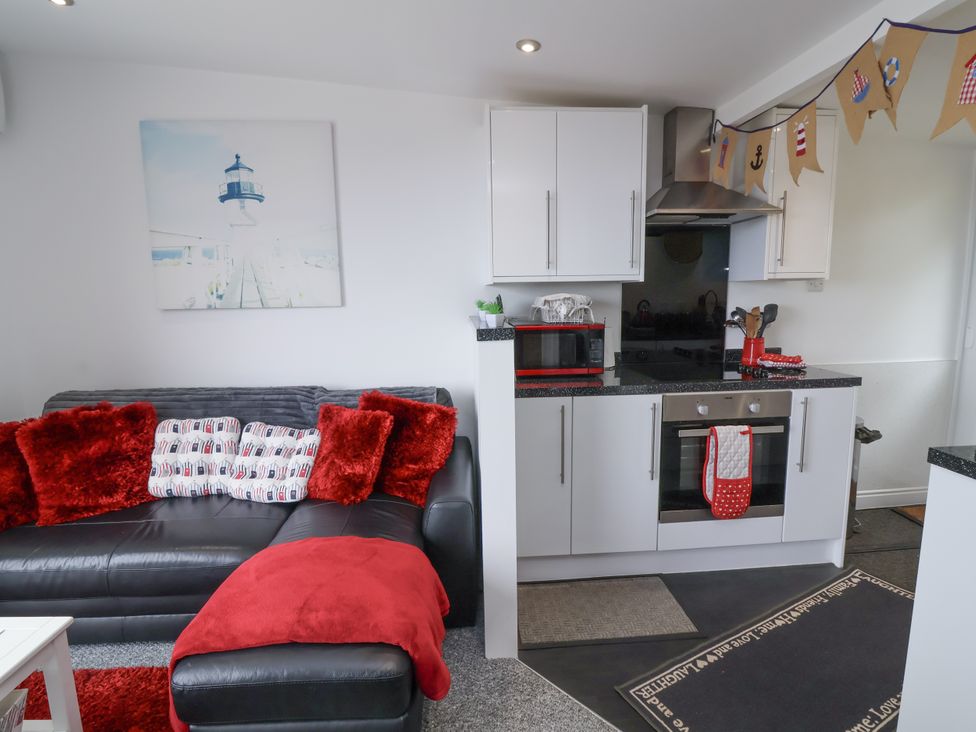 A kitchen area with a sofa and kitchen appliances at I C Lundy Too near Bideford Bay Holiday Park