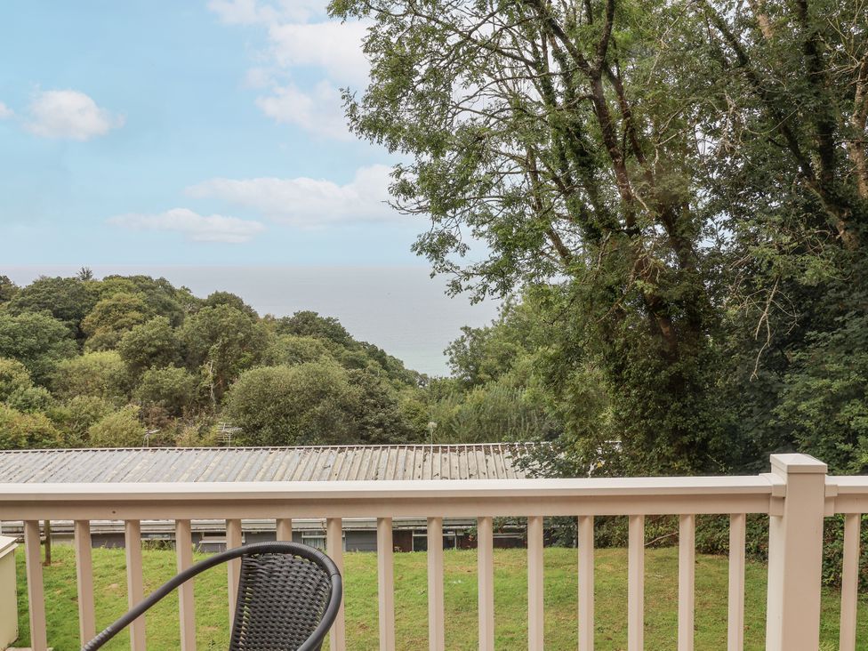 A view of the sea and trees from a balcony at I C Lundy Too Bideford Bay Holiday Park near Woolfardisworthy