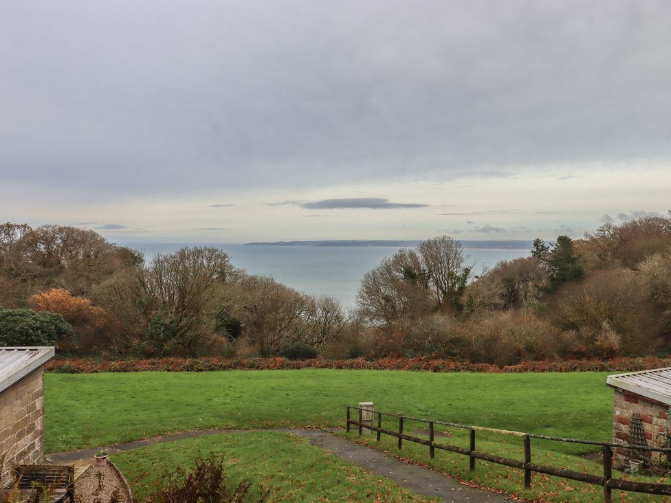 A view of the sea with trees and grass at I C Lundy Too Bideford Bay Holiday Park near Woolfardisworthy