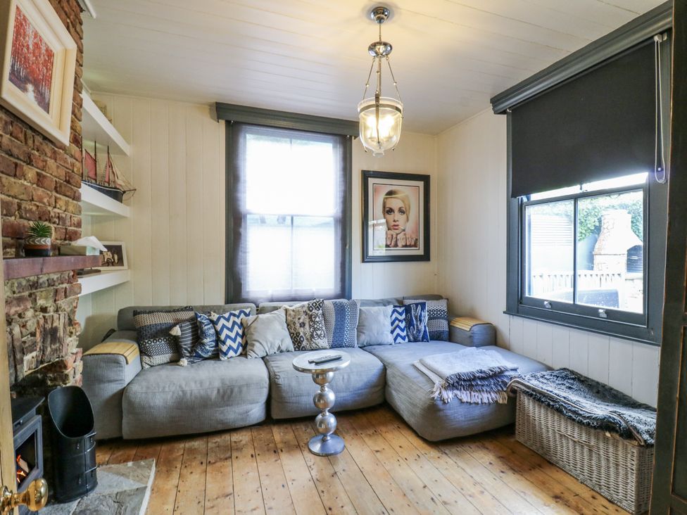 A living room with a sofa and coffee table at 14 Marine Terrace in Whitstable